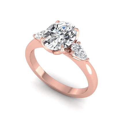 Oval & Pear Three Stone Lab Grown Diamond Engagement Ring featuring a 9.00 × 7.00 mm IGI Certified oval-cut center diamond with pear-cut side diamonds in rose gold.