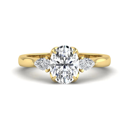 Oval & Pear Three Stone Lab Grown Diamond Engagement Ring featuring a 9.00 × 7.00 mm IGI Certified oval-cut center diamond with pear-cut side diamonds in yellow gold.