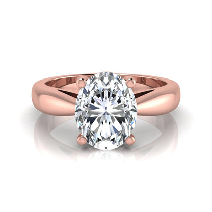 Oval cut lab grown diamond solitaire engagement ring with a four prong setting and rose gold tone band.