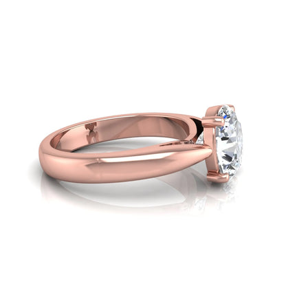 Oval cut lab grown diamond solitaire engagement ring with a four prong setting and rose gold tone band.