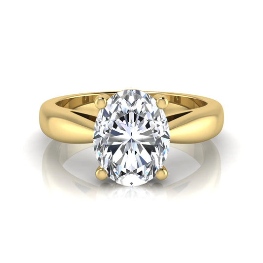 Oval cut lab grown diamond solitaire engagement ring with a four prong setting and yellow gold tone band.