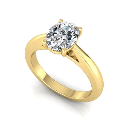 Oval cut lab grown diamond solitaire engagement ring featuring a classic four-prong setting with a polished yellow gold cathedral-style band.