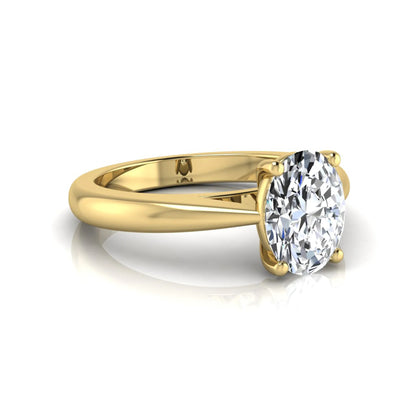 Oval cut lab grown diamond solitaire engagement ring featuring a classic four-prong setting with a polished yellow gold cathedral-style band.