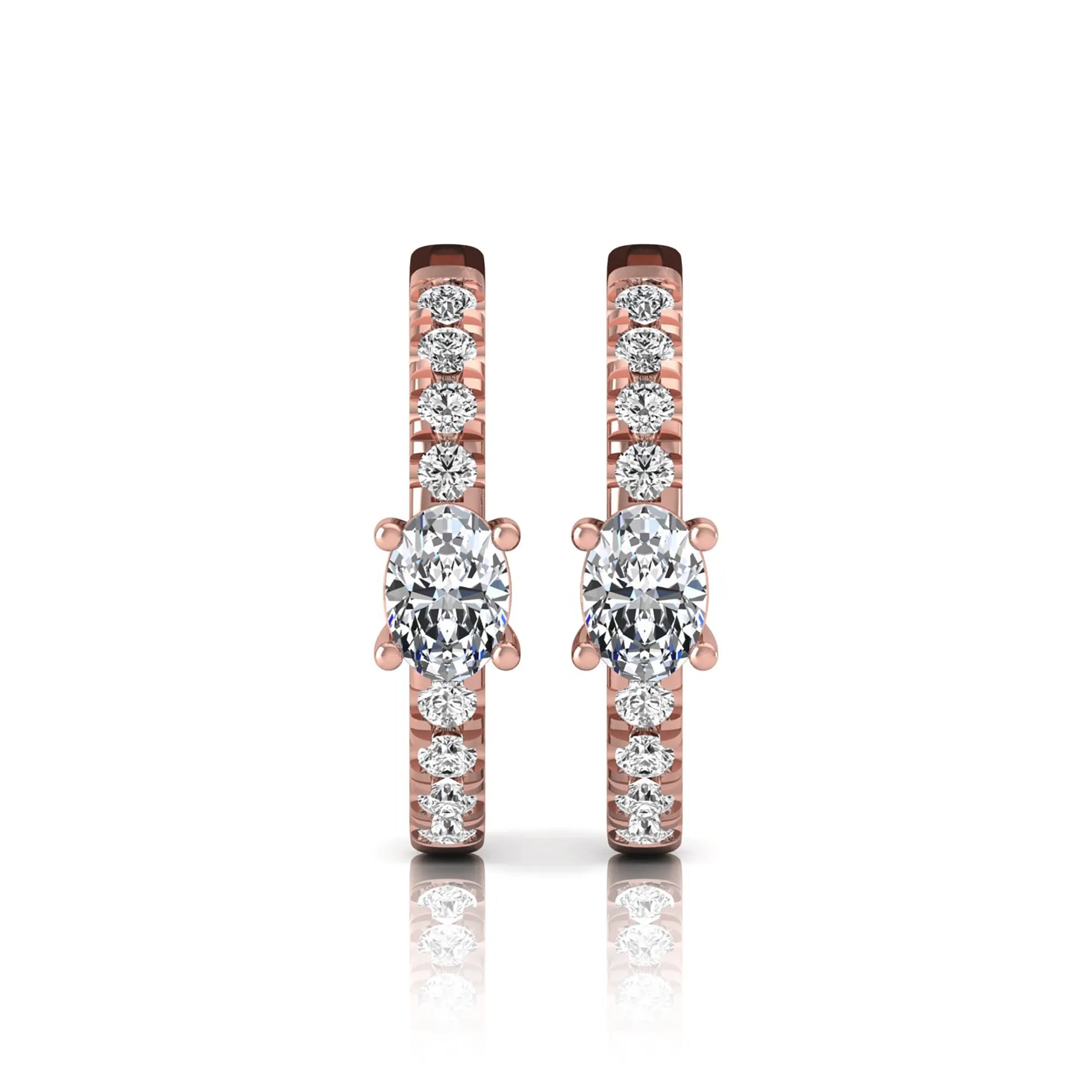 Oval and round lab grown diamond pavé huggie hoop earrings featuring a four prong oval center diamond with graduated shared prong round diamond accents in rose gold.