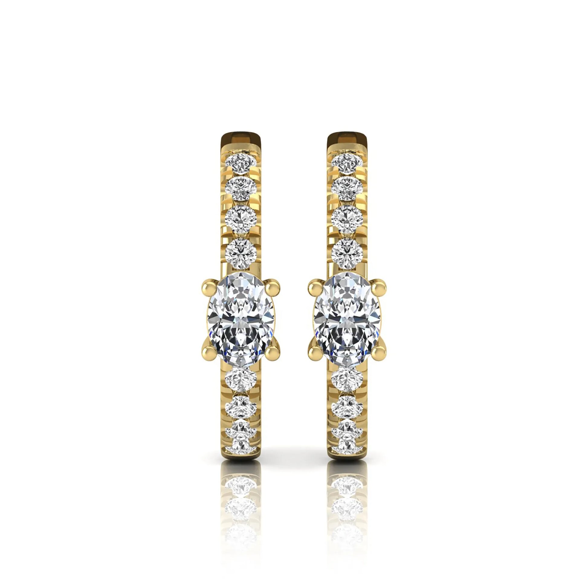 Oval and round lab grown diamond pavé huggie hoop earrings featuring a four prong oval center diamond with graduated shared prong round diamond accents in yellow gold.