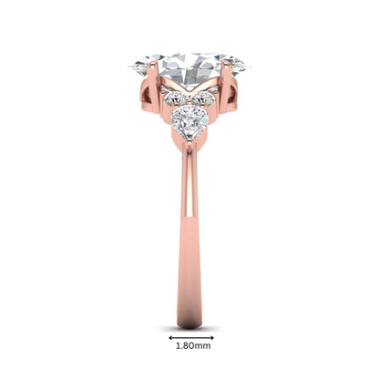Oval Seven Stone Lab Grown Diamond Engagement Ring featuring a 10.00 × 7.00 mm oval-cut center diamond with round and pear-cut side diamonds in a multi-prong setting in rose gold
