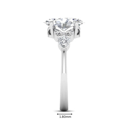 Oval Seven Stone Lab Grown Diamond Engagement Ring featuring a 10.00 × 7.00 mm oval-cut center diamond with round and pear-cut side diamonds in a multi-prong setting in white gold