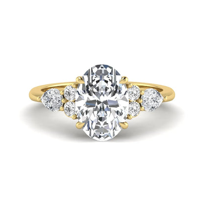 Oval Seven Stone Lab Grown Diamond Engagement Ring featuring a 10.00 × 7.00 mm oval-cut center diamond with round and pear-cut side diamonds in a multi-prong setting in yellow gold