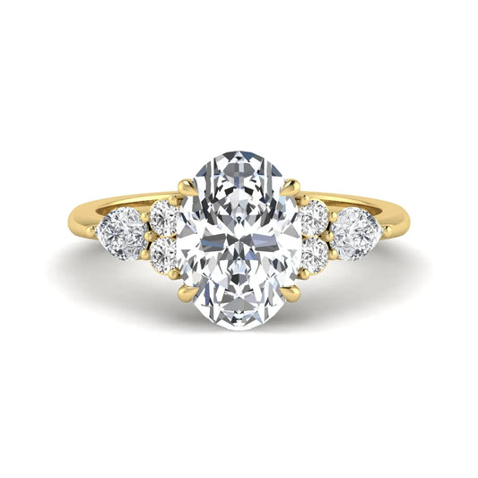 Oval Seven Stone Lab Grown Diamond Engagement Ring featuring a 10.00 × 7.00 mm oval-cut center diamond with round and pear-cut side diamonds in a multi-prong setting in yellow gold