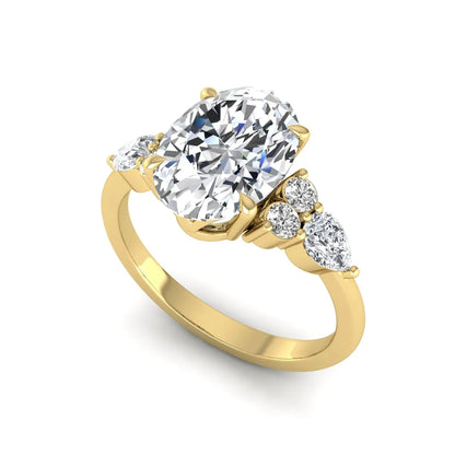 Oval Seven Stone Lab Grown Diamond Engagement Ring featuring a 10.00 × 7.00 mm oval-cut center diamond with round and pear-cut side diamonds in a multi-prong setting in yellow gold
