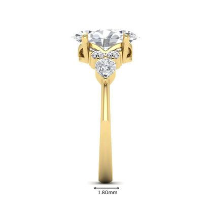 Oval Seven Stone Lab Grown Diamond Engagement Ring featuring a 10.00 × 7.00 mm oval-cut center diamond with round and pear-cut side diamonds in a multi-prong setting in yellow gold