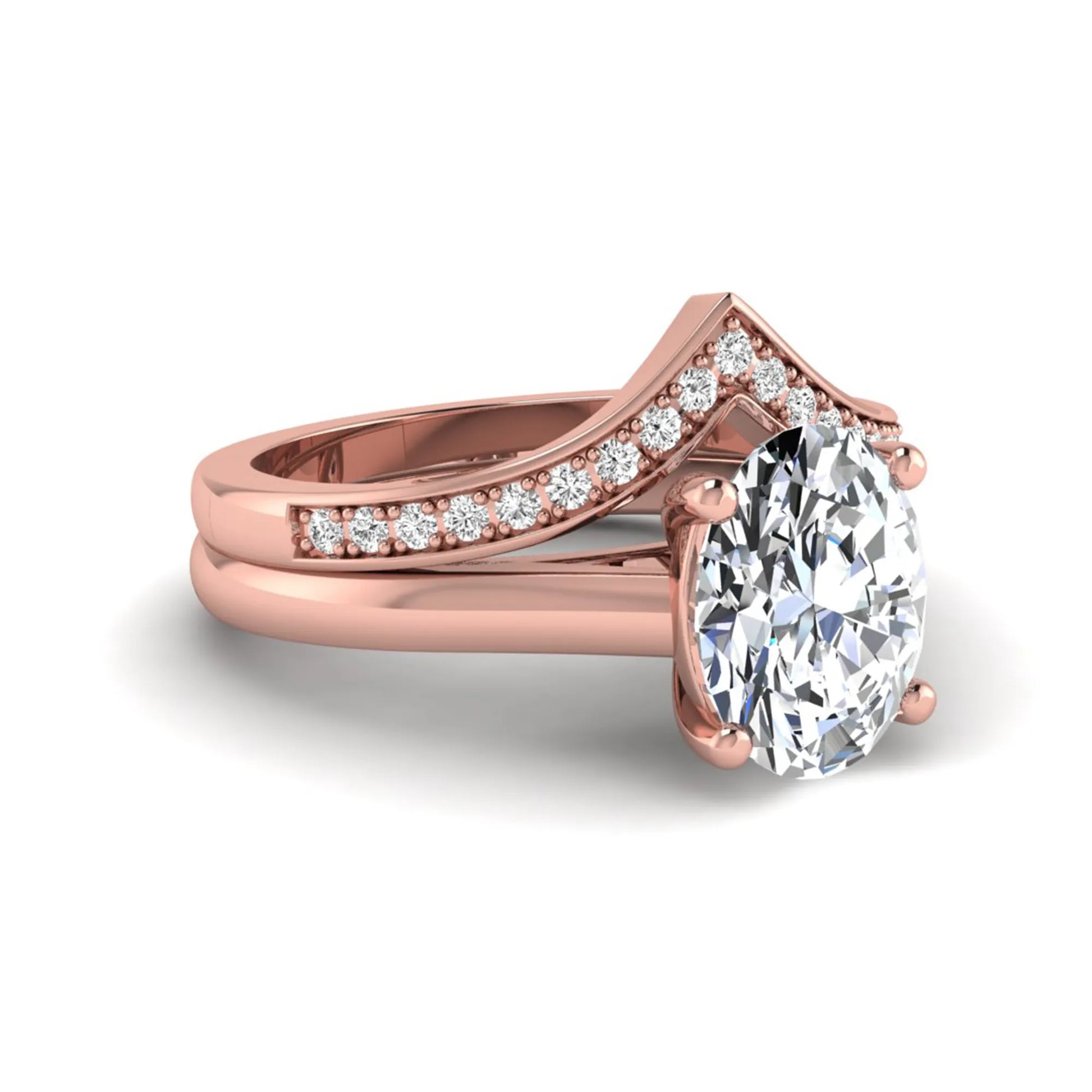 Oval cut lab grown diamond bridal ring set featuring a four-prong solitaire engagement ring with a pavé chevron V-shaped wedding band in a rose gold finish.