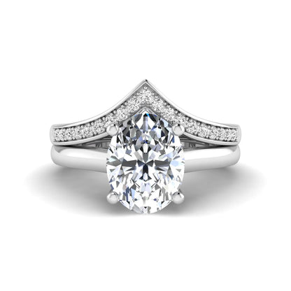 Oval cut lab grown diamond bridal ring set featuring a four-prong solitaire engagement ring with a pavé chevron V-shaped wedding band in a white gold finish.