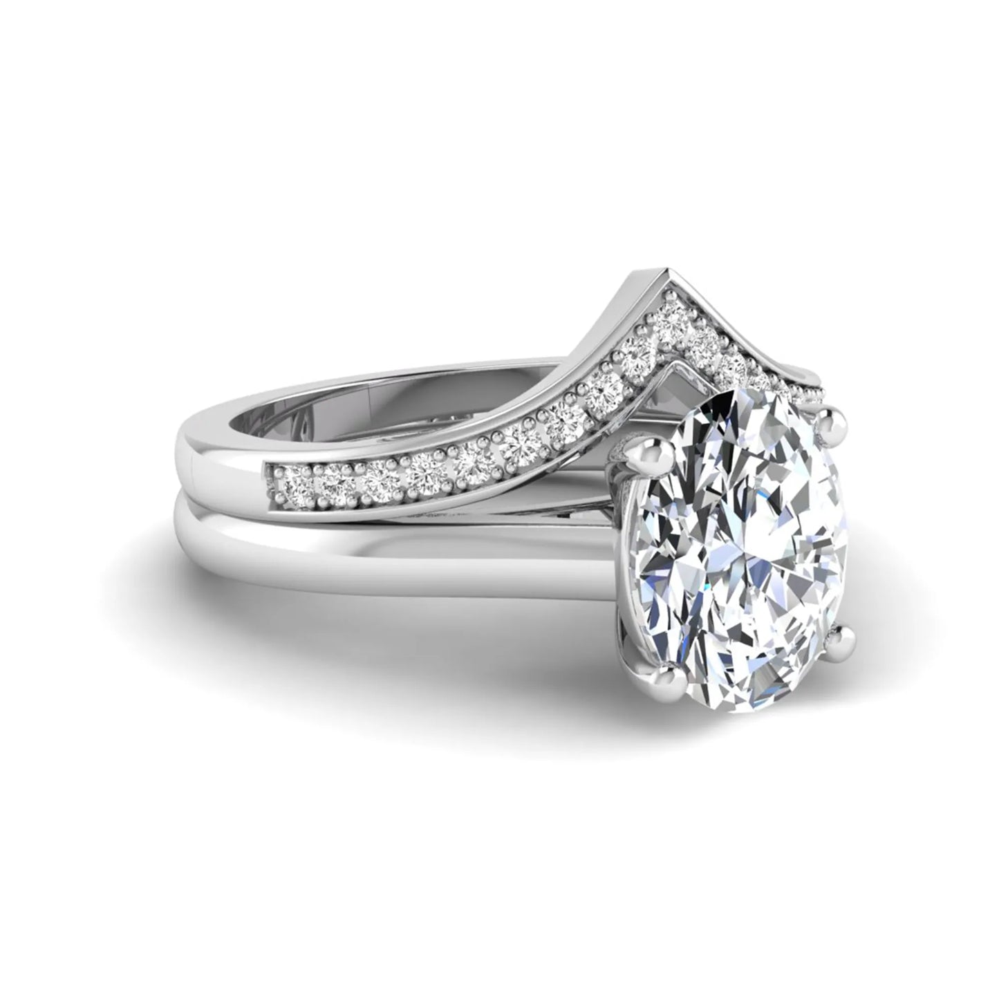 Oval cut lab grown diamond bridal ring set featuring a four-prong solitaire engagement ring with a pavé chevron V-shaped wedding band in a white gold finish.