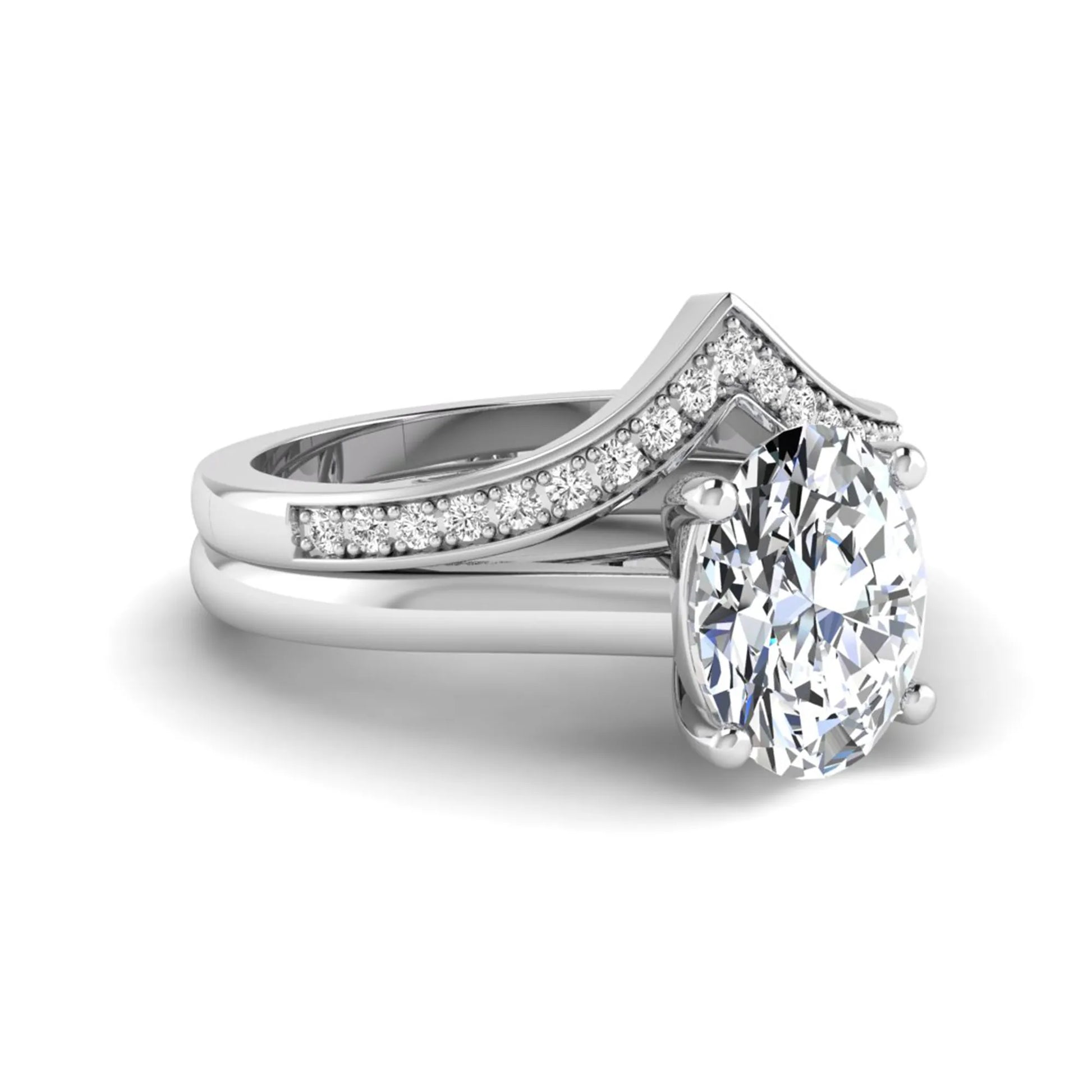 Oval cut lab grown diamond bridal ring set featuring a four-prong solitaire engagement ring with a pavé chevron V-shaped wedding band in a white gold finish.