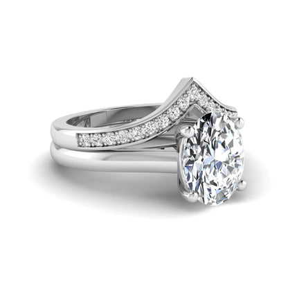 Oval cut lab grown diamond bridal ring set featuring a four-prong solitaire engagement ring with a pavé chevron V-shaped wedding band in a white gold finish.