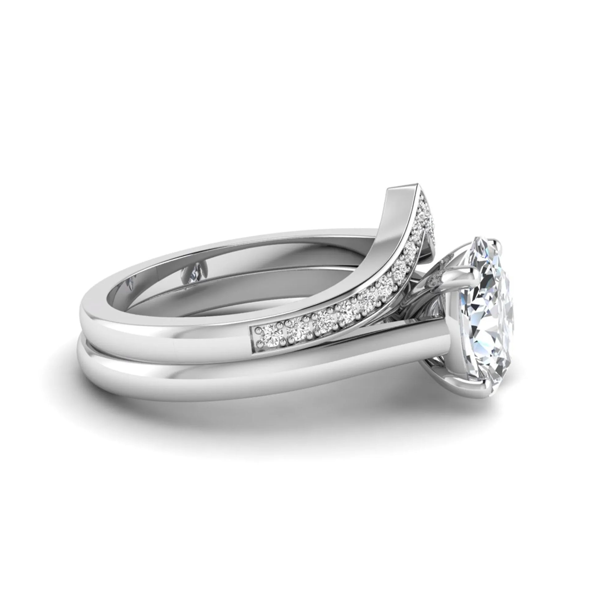 Oval cut lab grown diamond bridal ring set featuring a four-prong solitaire engagement ring with a pavé chevron V-shaped wedding band in a white gold finish.
