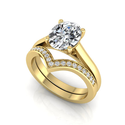 Oval cut lab grown diamond bridal ring set featuring a four-prong solitaire engagement ring with a pavé chevron V-shaped wedding band in a yellow gold finish.