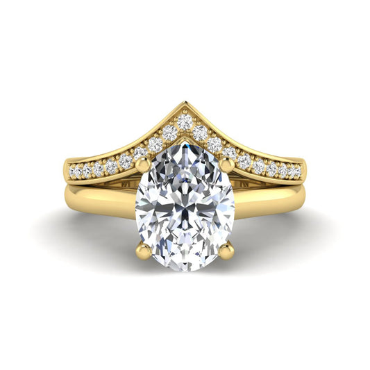 Oval cut lab grown diamond bridal ring set featuring a four-prong solitaire engagement ring with a pavé chevron V-shaped wedding band in a yellow gold finish.