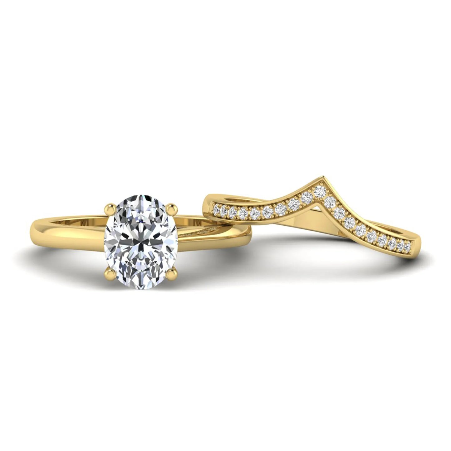 Oval cut lab grown diamond bridal ring set featuring a four-prong solitaire engagement ring with a pavé chevron V-shaped wedding band in a yellow gold finish.