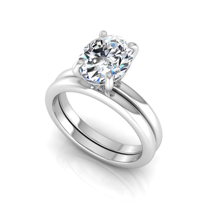 Oval cut lab grown diamond solitaire engagement ring with a matching plain gold wedding band in white gold