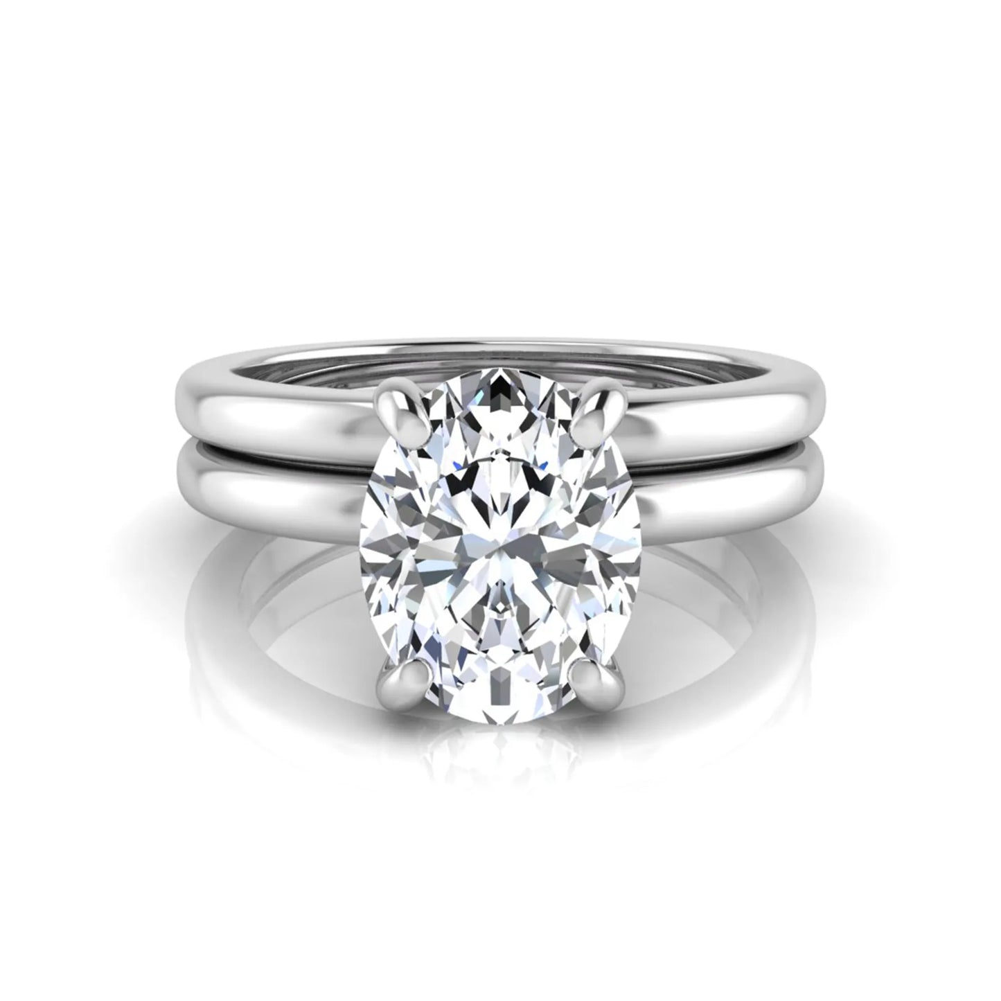 Oval cut lab grown diamond solitaire engagement ring with a matching plain gold wedding band in white gold