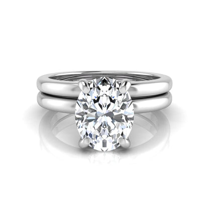 Oval cut lab grown diamond solitaire engagement ring with a matching plain gold wedding band in white gold
