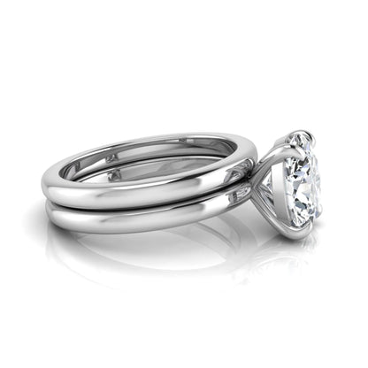 Oval cut lab grown diamond solitaire engagement ring with a matching plain gold wedding band in white gold