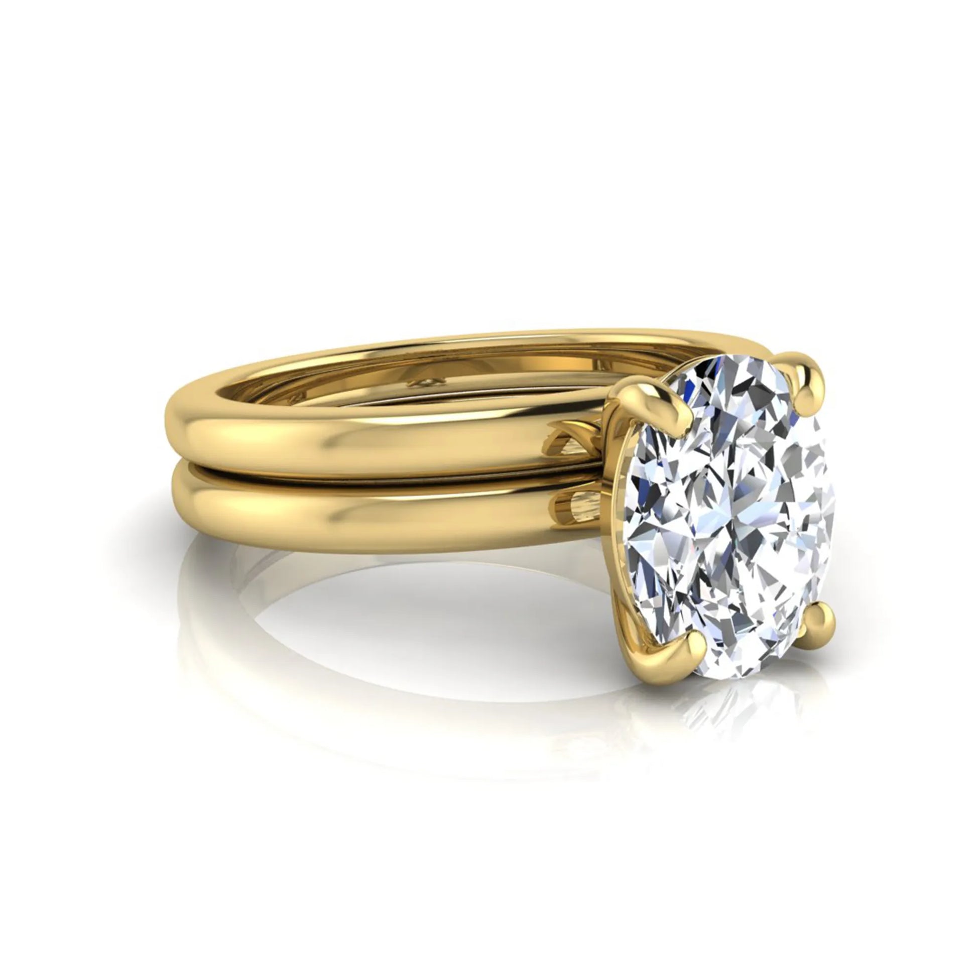 Oval cut lab grown diamond solitaire engagement ring with a matching plain gold wedding band in yellow gold