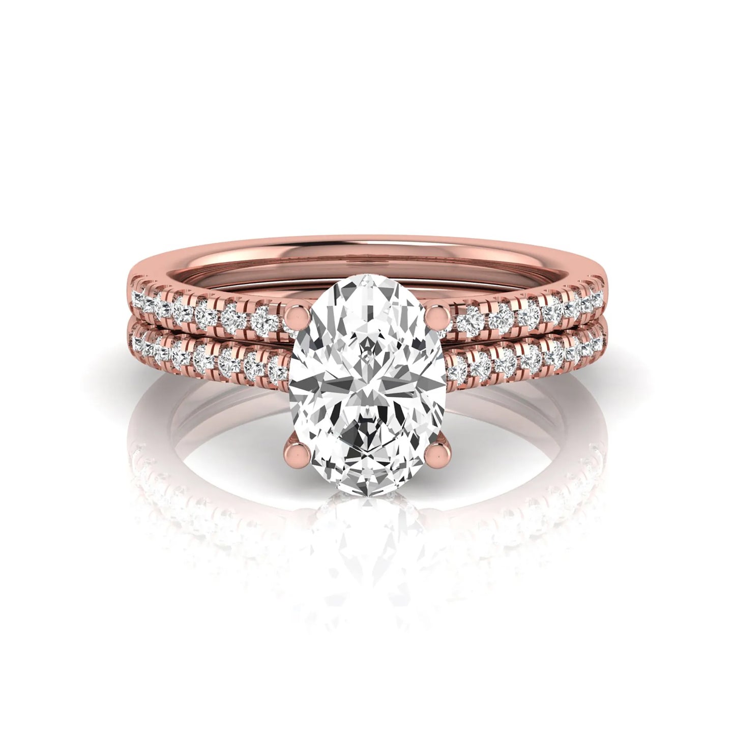 Oval cut lab grown diamond solitaire bridal ring set featuring a four-prong center diamond with pavé diamond engagement ring and matching pavé wedding band in rose gold tone.