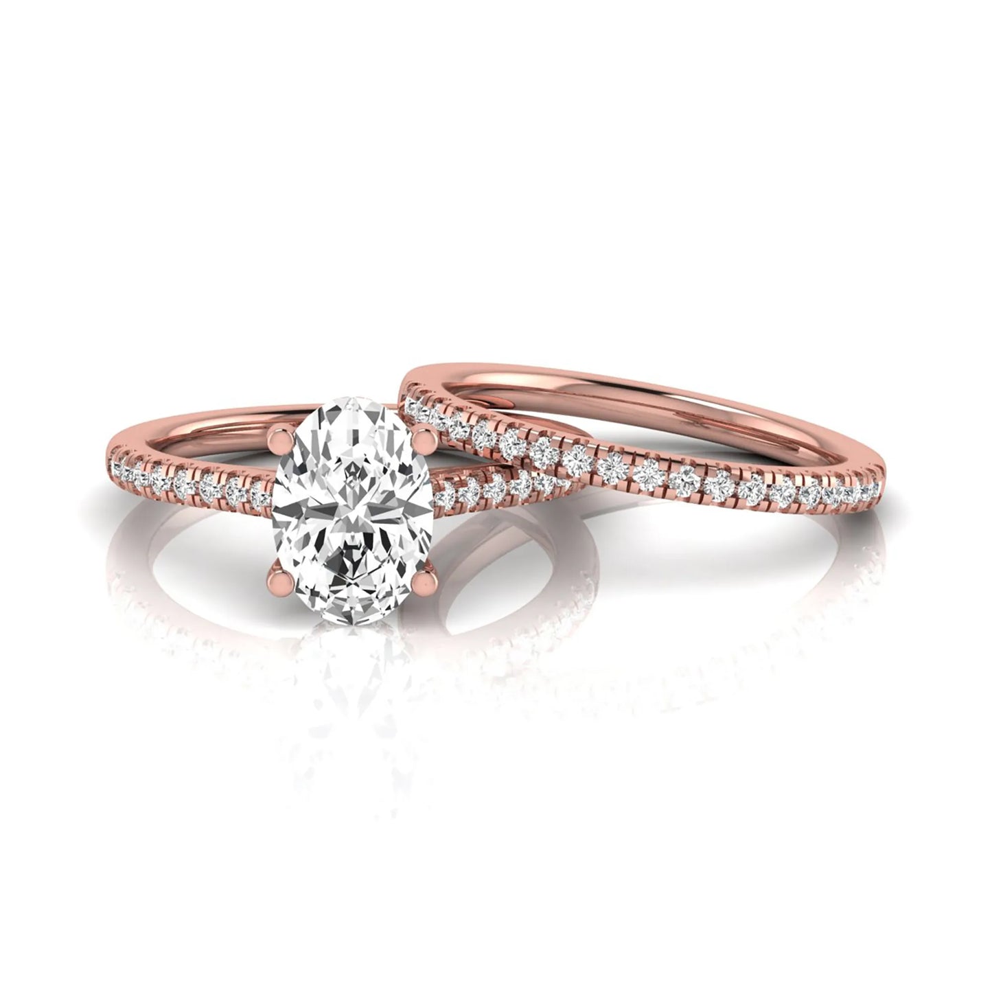 Oval cut lab grown diamond solitaire bridal ring set featuring a four-prong center diamond with pavé diamond engagement ring and matching pavé wedding band in rose gold tone.