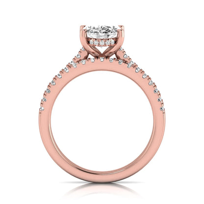 Oval cut lab grown diamond solitaire bridal ring set featuring a four-prong center diamond with pavé diamond engagement ring and matching pavé wedding band in rose gold tone.