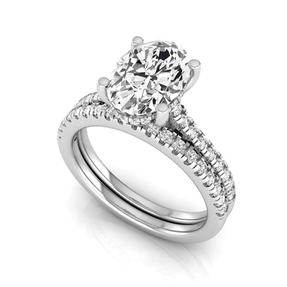 Oval cut lab grown diamond solitaire bridal ring set featuring a four-prong center diamond with pavé diamond engagement ring and matching pavé wedding band in white gold tone.