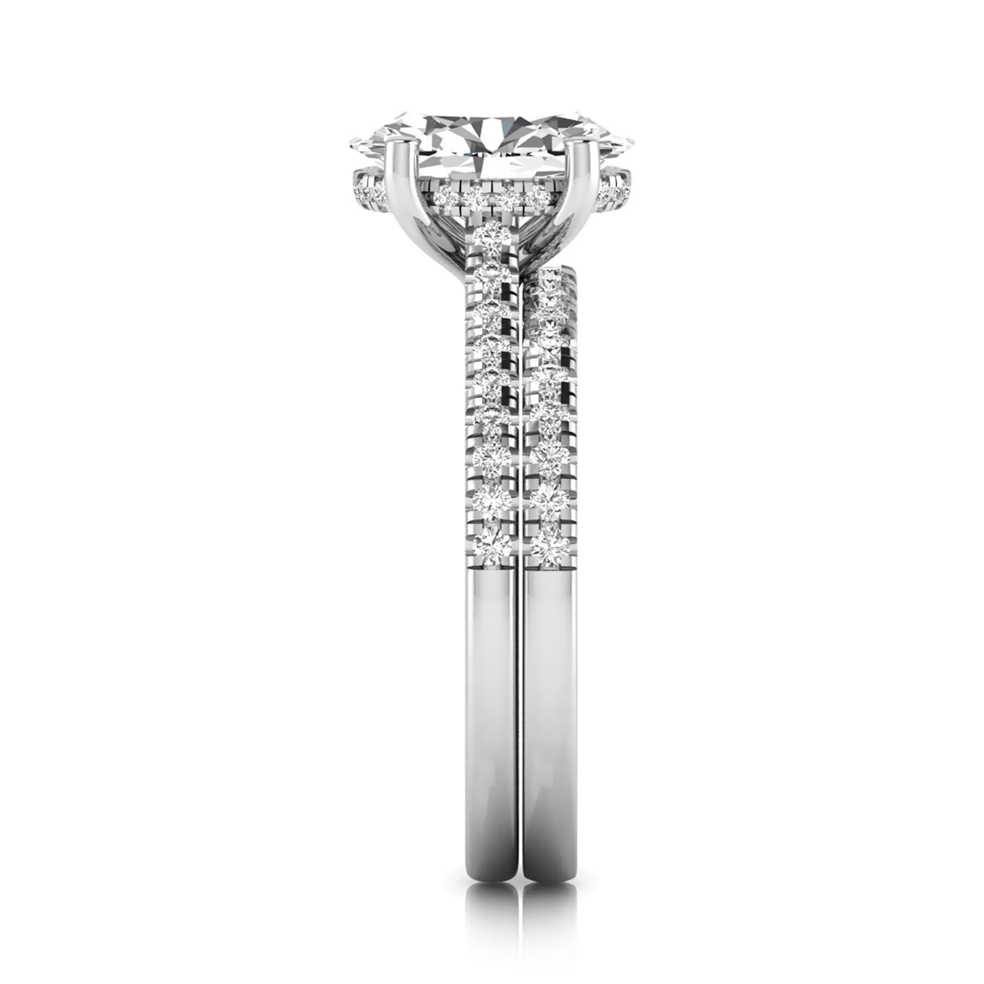 Oval cut lab grown diamond solitaire bridal ring set featuring a four-prong center diamond with pavé diamond engagement ring and matching pavé wedding band in white gold tone.