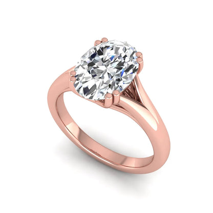 Oval cut lab grown diamond solitaire engagement ring with split shank design and rose gold tone prong setting.
