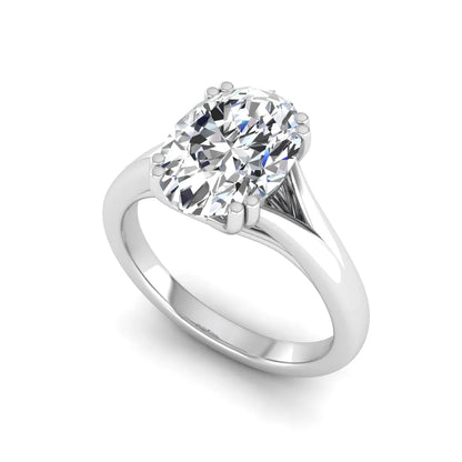 Oval cut lab grown diamond solitaire engagement ring with split shank design and white gold tone prong setting.