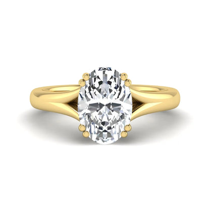 Oval cut lab grown diamond solitaire engagement ring with split shank design and yellow gold tone prong setting.