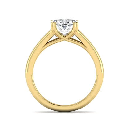 Oval cut lab grown diamond solitaire engagement ring with split shank design and yellow gold tone prong setting.