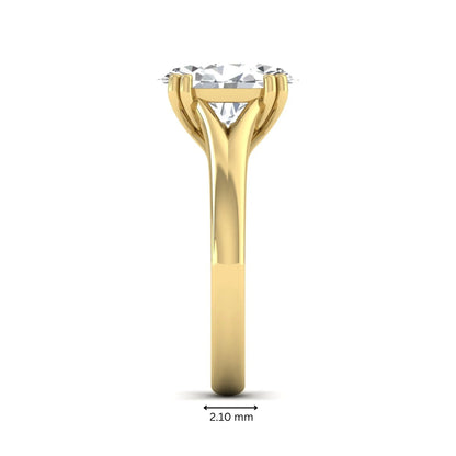 Oval cut lab grown diamond solitaire engagement ring with split shank design and yellow gold tone prong setting.
