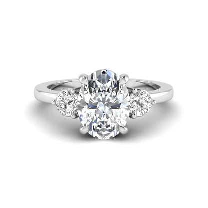 Oval cut three stone lab grown diamond engagement ring featuring a 1.21 carat IGI certified center diamond with round side diamonds in white gold.