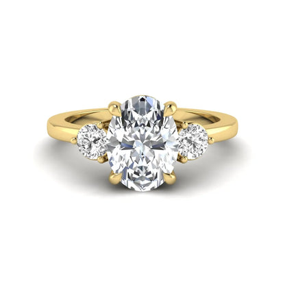 Oval cut three stone lab grown diamond engagement ring featuring a 1.21 carat IGI certified center diamond with round side diamonds in yellow gold.