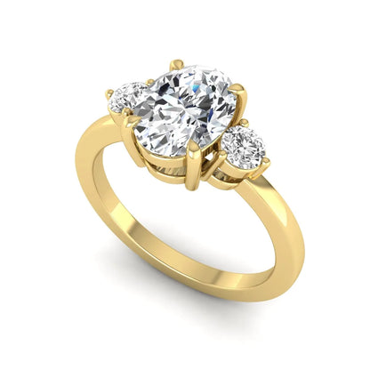 Oval cut three stone lab grown diamond engagement ring featuring a 1.21 carat IGI certified center diamond with round side diamonds in yellow gold.