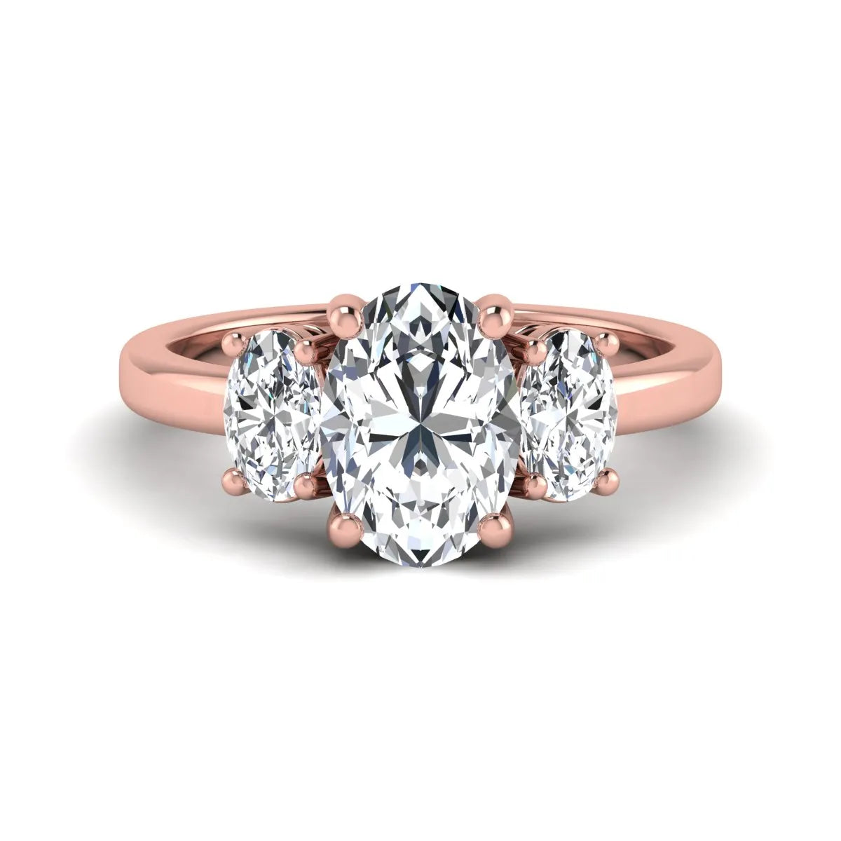 Oval cut three stone lab grown diamond engagement ring featuring an IGI certified center diamond with matching oval side diamonds in rose gold.