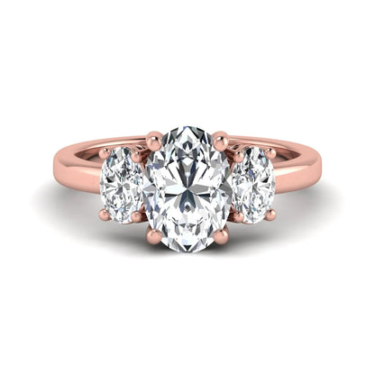 Oval cut three stone lab grown diamond engagement ring featuring an IGI certified center diamond with matching oval side diamonds in rose gold.