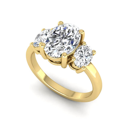 Oval cut three stone lab grown diamond engagement ring featuring an IGI certified center diamond with matching oval side diamonds in yellow gold.