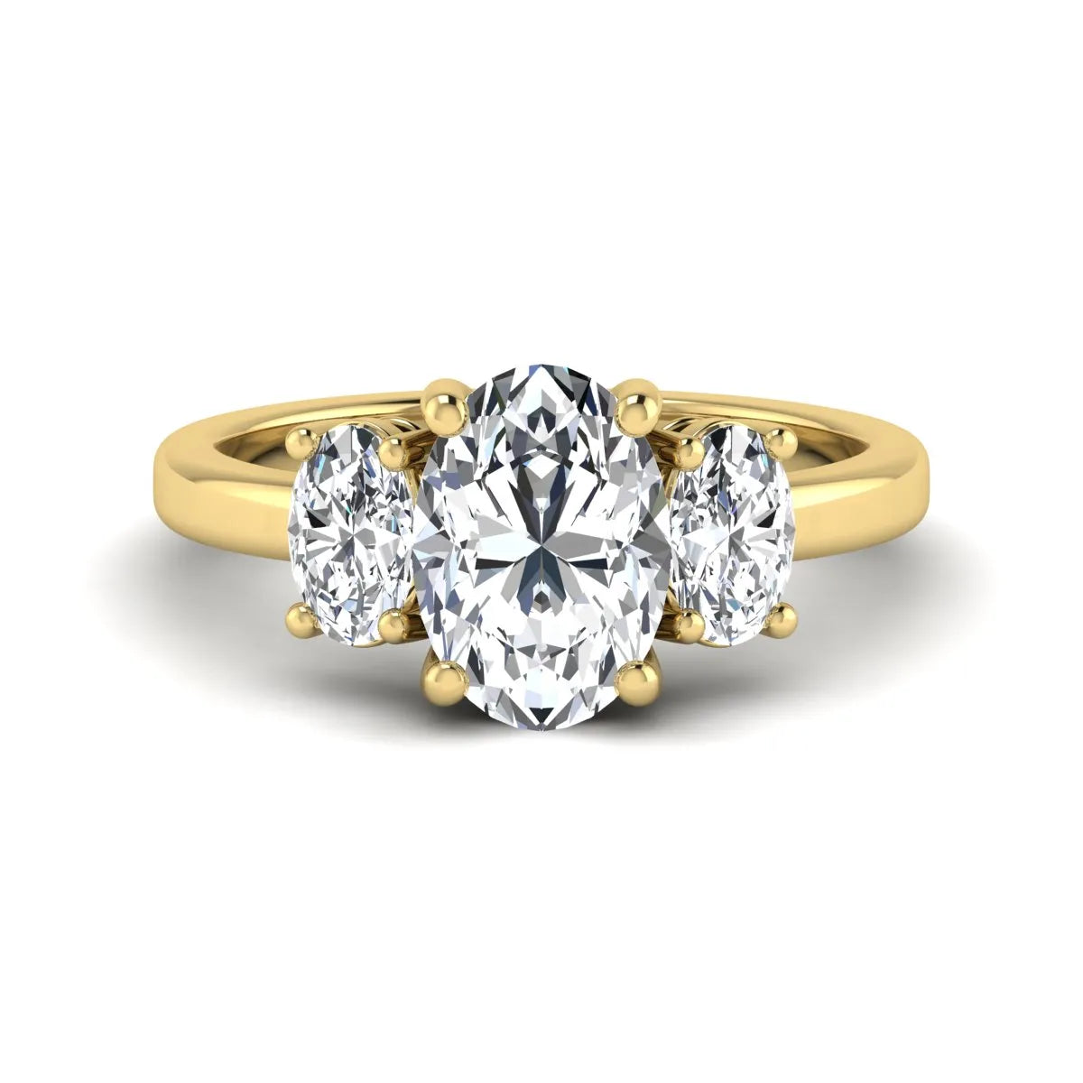 Oval cut three stone lab grown diamond engagement ring featuring an IGI certified center diamond with matching oval side diamonds in yellow gold.