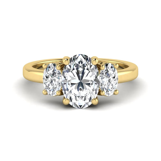 Oval cut three stone lab grown diamond engagement ring featuring an IGI certified center diamond with matching oval side diamonds in yellow gold.