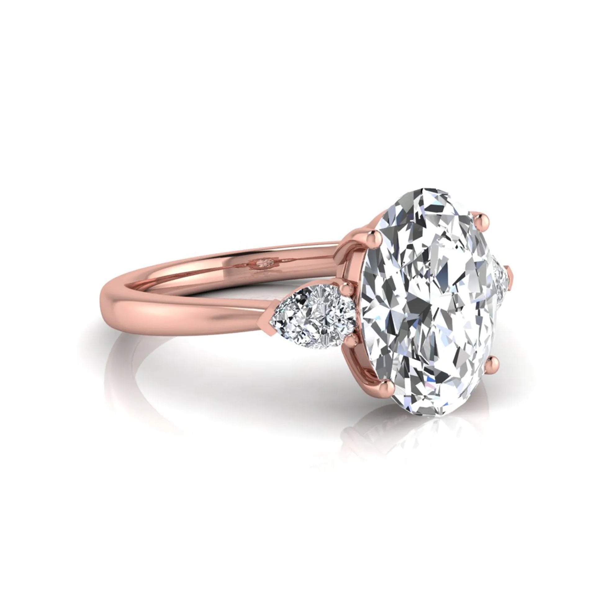 Oval three stone lab grown diamond engagement ring featuring a 1.86 carat IGI certified oval cut center diamond with pear cut side diamonds in a rose gold design.