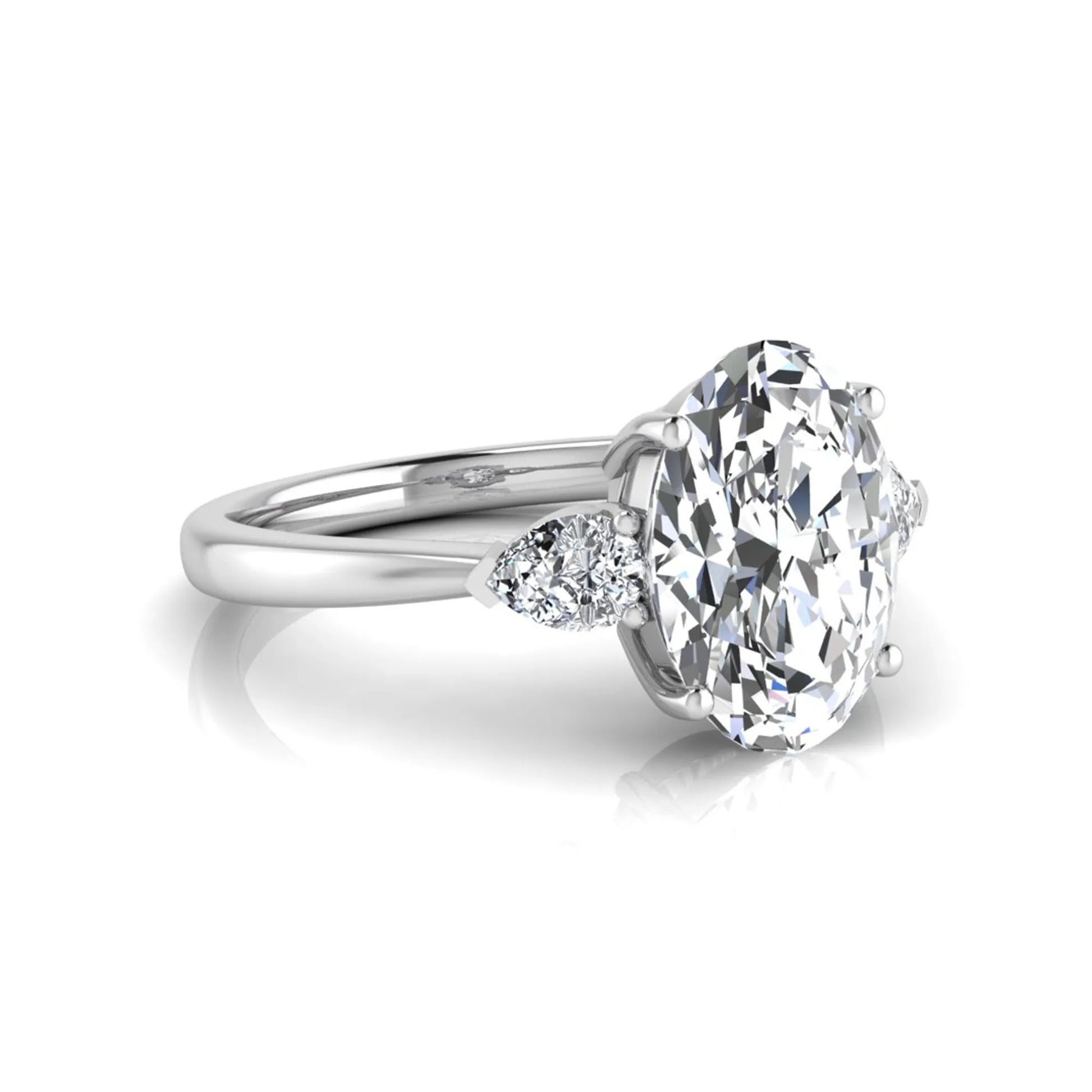 Oval three stone lab grown diamond engagement ring featuring a 1.86 carat IGI certified oval cut center diamond with pear cut side diamonds in a white gold design.