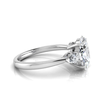 Oval three stone lab grown diamond engagement ring featuring a 1.86 carat IGI certified oval cut center diamond with pear cut side diamonds in a white gold design.